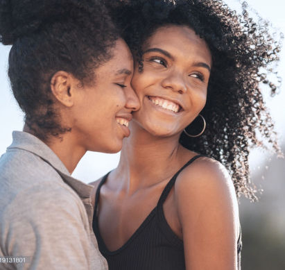 image-two-adults-of-colour-joyfully-embracing